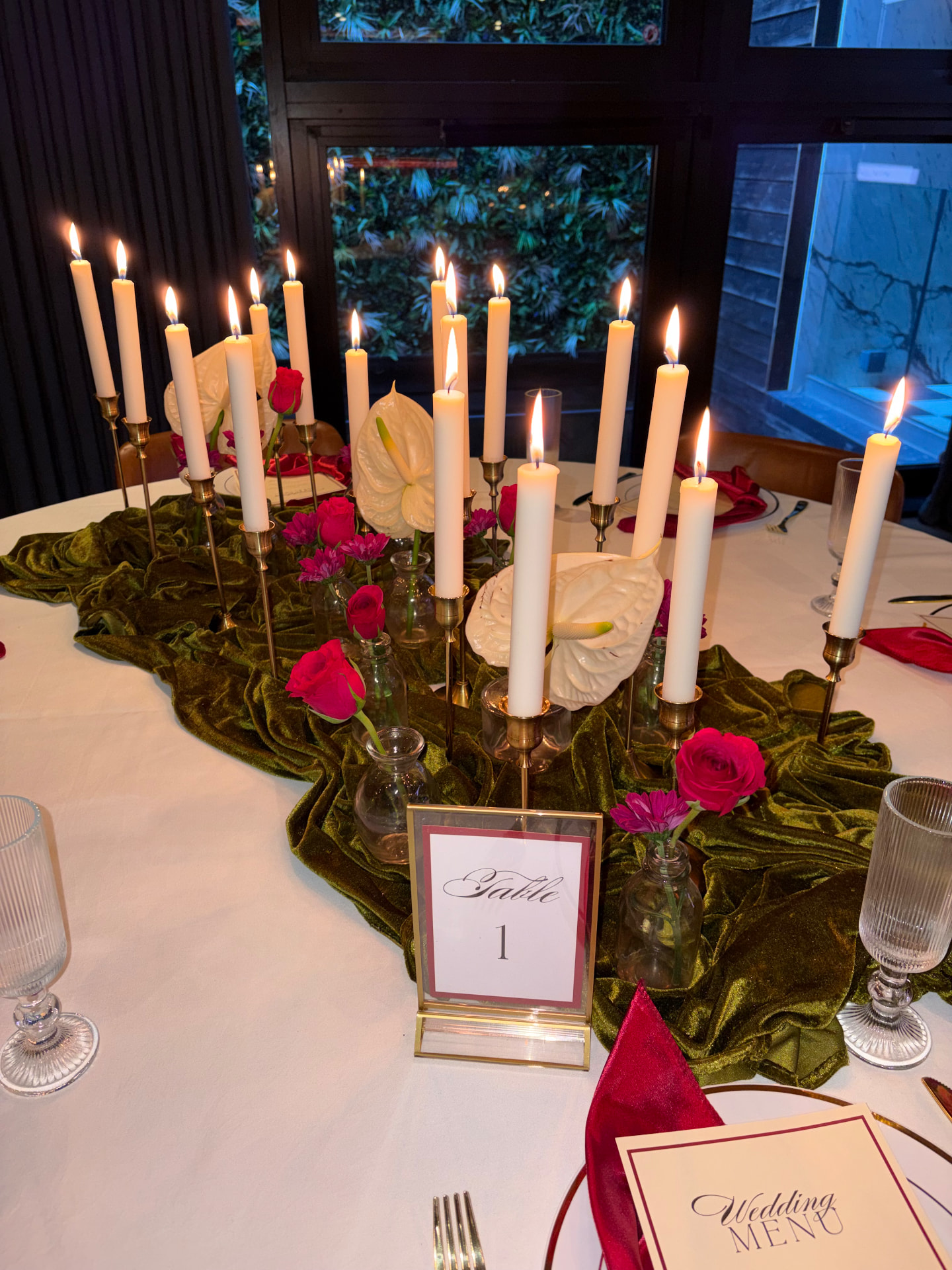 Taper candles, olive velvet runner, roses and anthuriums
